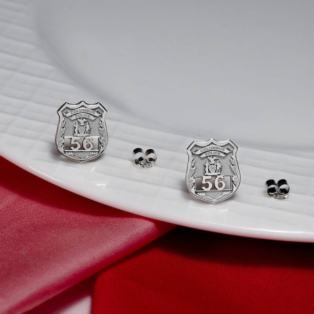 Police badge earrings displayed on a red velvet presentation cloth (PG102433, secondary photo 3)