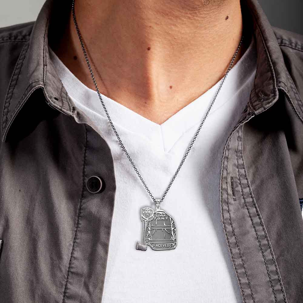 Firefighter uniform pendant necklace worn over a light shirt. (PG102878, secondary photo 1)