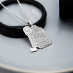Silver firefighter uniform pendant displayed on a dark surface. (PG102878, secondary photo 4)