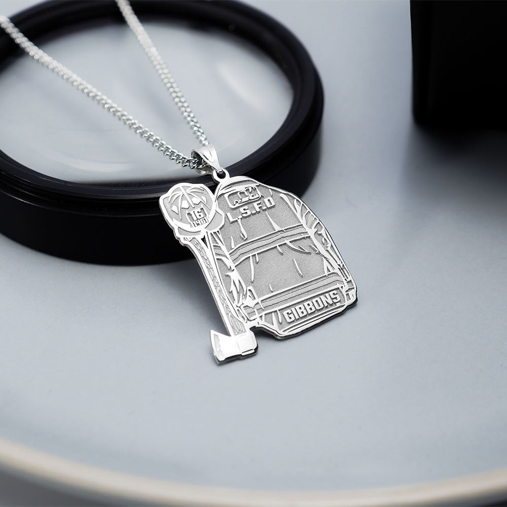 Silver firefighter uniform pendant displayed on a dark surface. (PG102878, secondary photo 4)