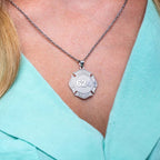 Firefighter badge necklace worn with a turquoise top. (PG71196, secondary photo 2)