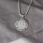 Silver firefighter badge necklace worn with a dark top. (PG71196, secondary photo 4)