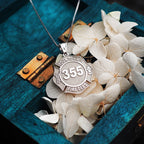 Firefighter badge pendant photographed with white flowers. (PG71196, secondary photo 7)