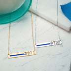Silver and gold thin-blue-line bar necklaces arranged on a light surface (PG93919, secondary photo 7)